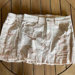 two different sized light pink jean skirts!